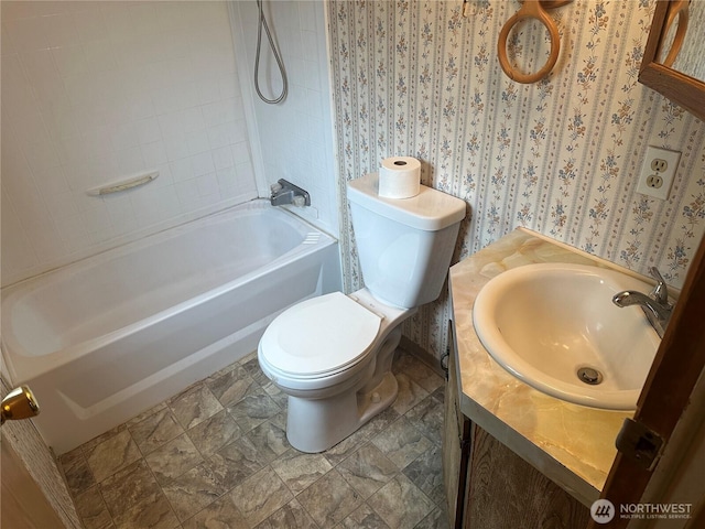 10206 218th Ave E, Bonney Lake, WA 98391 - full bath with wallpapered walls, stone finish flooring, toilet, shower / washtub combination, and vanity