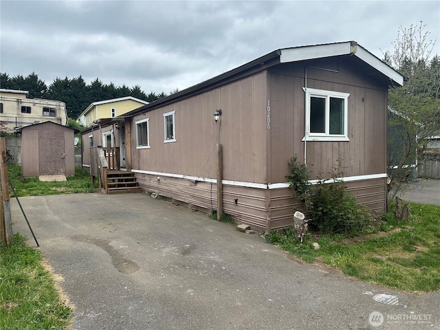 10206 218th Ave E, Bonney Lake, WA 98391 - view of property exterior featuring an outdoor structure and a storage shed