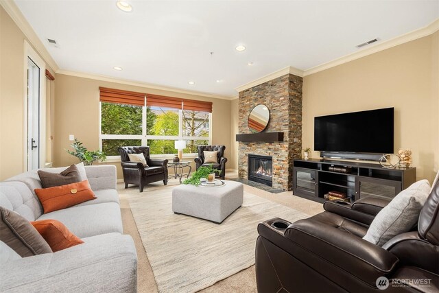 carpeted living room with visible vents, recessed lighting, crown molding, and a fireplace