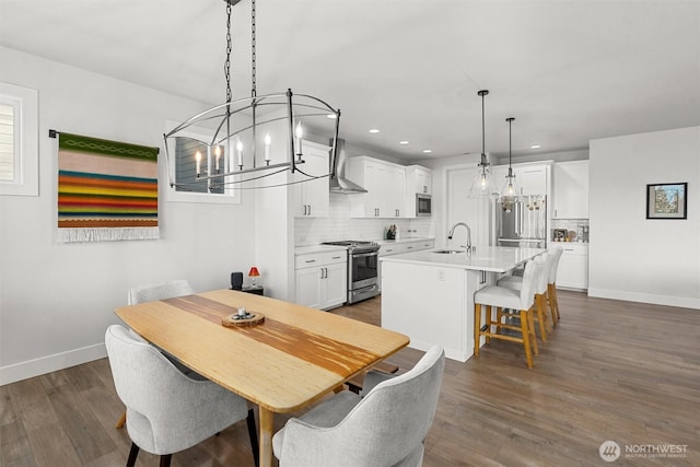 dining room featuring baseboards, dark wood-style floors, and an inviting chandelier