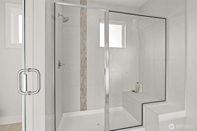 full bath featuring baseboards and a stall shower