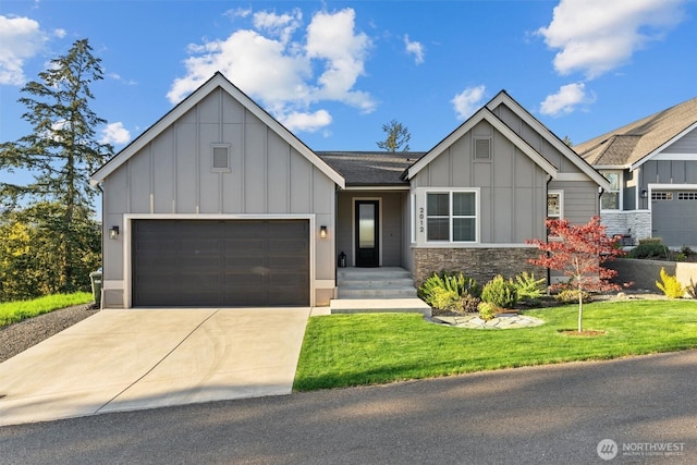 view of front of property featuring a front lawn, stone siding, board and batten siding, an attached garage, and driveway