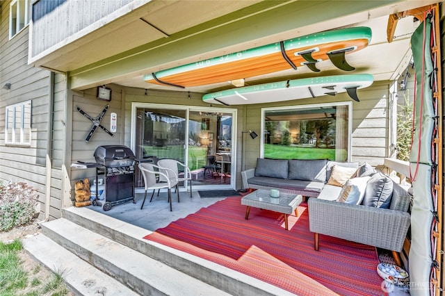 wooden terrace featuring an outdoor living space and grilling area