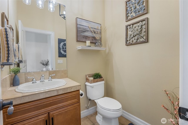 bathroom with baseboards, tile patterned floors, toilet, and vanity