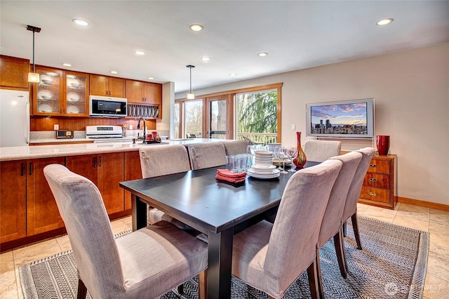 dining space featuring recessed lighting and baseboards