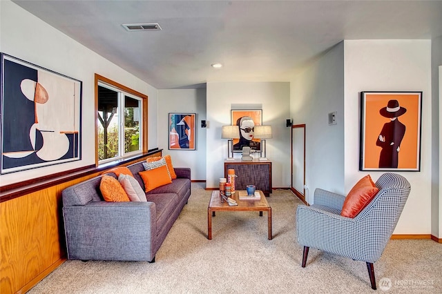 living room featuring carpet flooring, visible vents, and baseboards