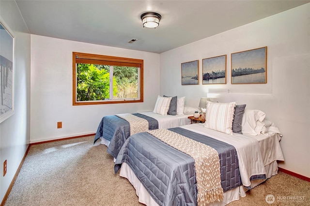 bedroom featuring visible vents, carpet, and baseboards