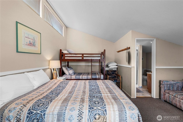 carpeted bedroom with lofted ceiling