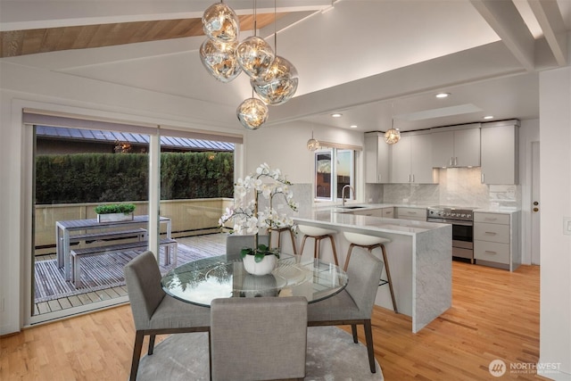 10837 Bill Point Blf NE, Bainbridge Island, WA 98110 - dining space featuring vaulted ceiling with beams, light wood-style floors, and a chandelier