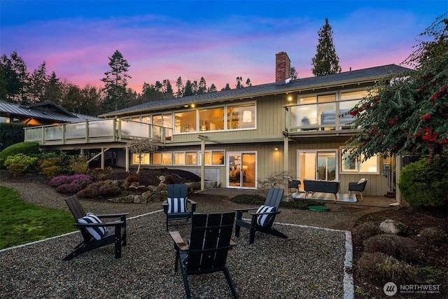 10837 Bill Point Blf NE, Bainbridge Island, WA 98110 - rear view of property featuring a fire pit, a patio area, a balcony, and a chimney