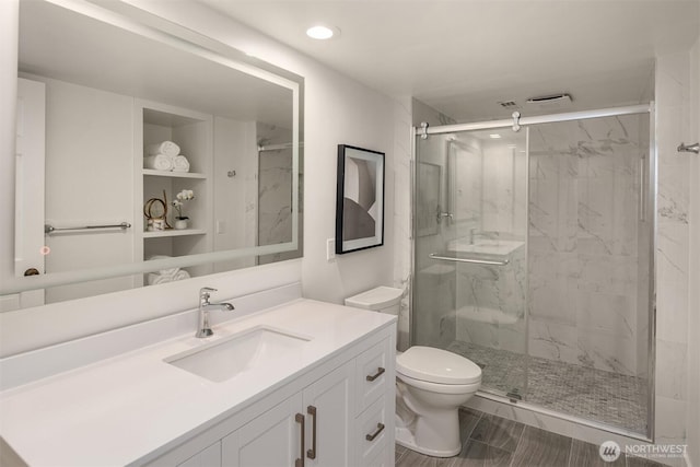 10837 Bill Point Blf NE, Bainbridge Island, WA 98110 - full bath with recessed lighting, a marble finish shower, vanity, and toilet