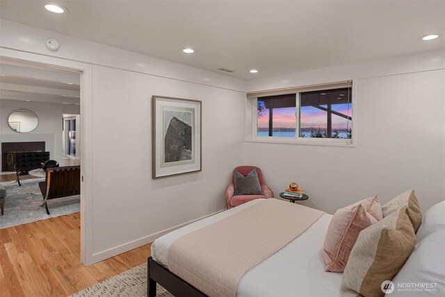 10837 Bill Point Blf NE, Bainbridge Island, WA 98110 - bedroom with recessed lighting, light wood finished floors, and a fireplace