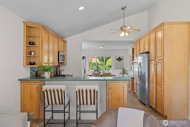 kitchen featuring a breakfast bar area, appliances with stainless steel finishes, open shelves, a peninsula, and lofted ceiling