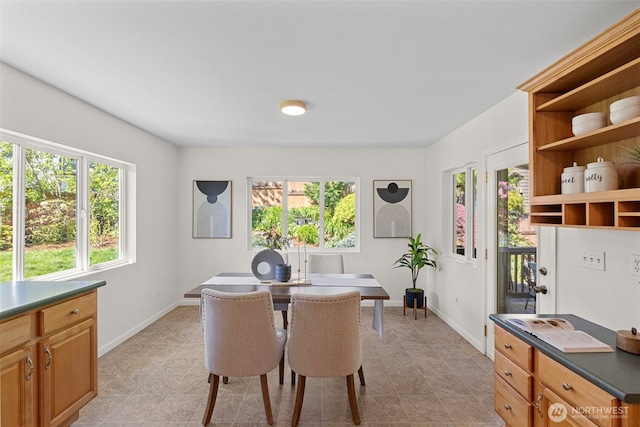 office with baseboards, light tile patterned flooring, and a wealth of natural light