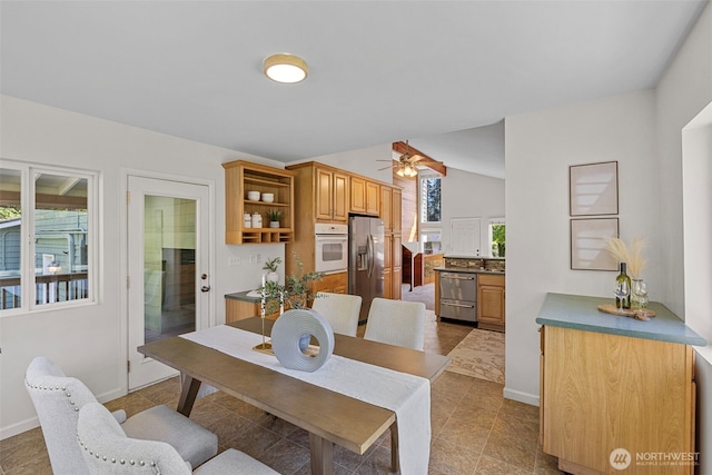 dining room featuring light tile patterned floors, baseboards, and a ceiling fan