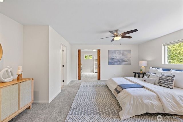 bedroom featuring baseboards, ceiling fan, and carpet