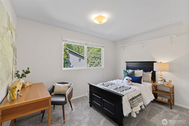 bedroom featuring baseboards and carpet flooring