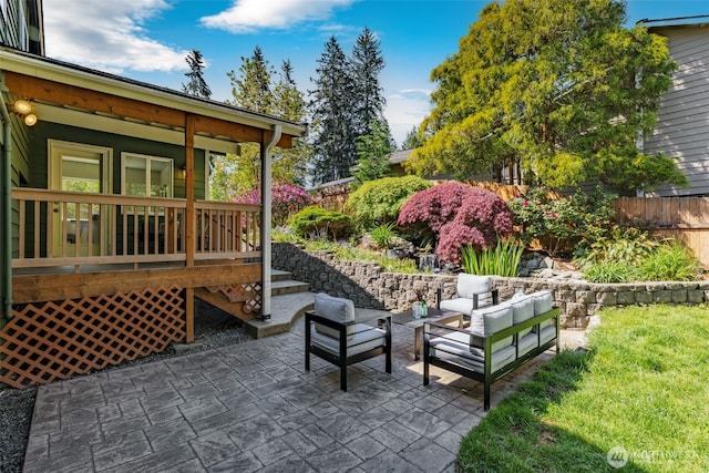 view of patio with an outdoor hangout area, fence, and a deck