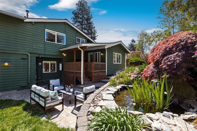 back of house with a patio, outdoor lounge area, and a deck