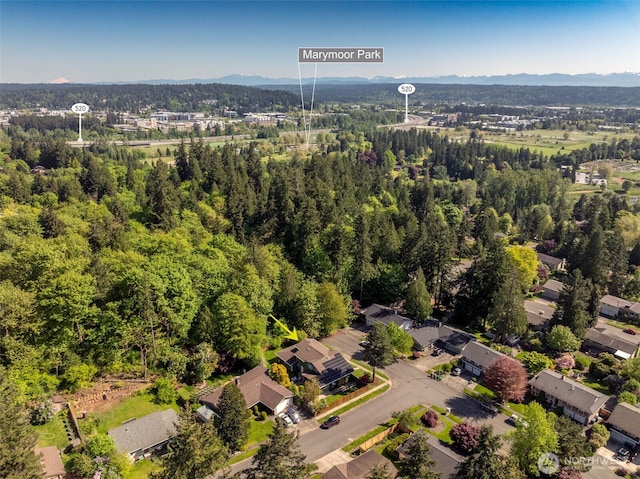 birds eye view of property with a view of trees and a mountain view