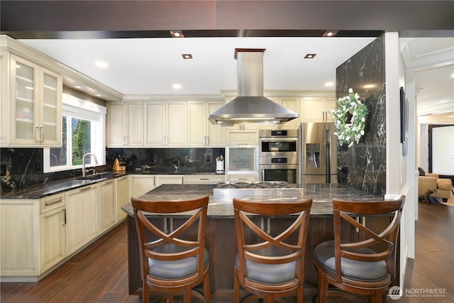 26217 137th Street Ct E, Buckley, WA 98321 - kitchen featuring a sink, dark wood finished floors, stainless steel appliances, island exhaust hood, and cream cabinetry