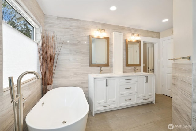 26217 137th Street Ct E, Buckley, WA 98321 - full bathroom with a sink, double vanity, a freestanding tub, and tile walls
