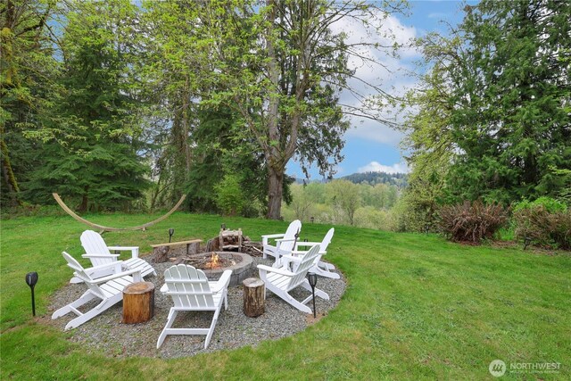 26217 137th Street Ct E, Buckley, WA 98321 - view of yard featuring a view of trees and a fire pit
