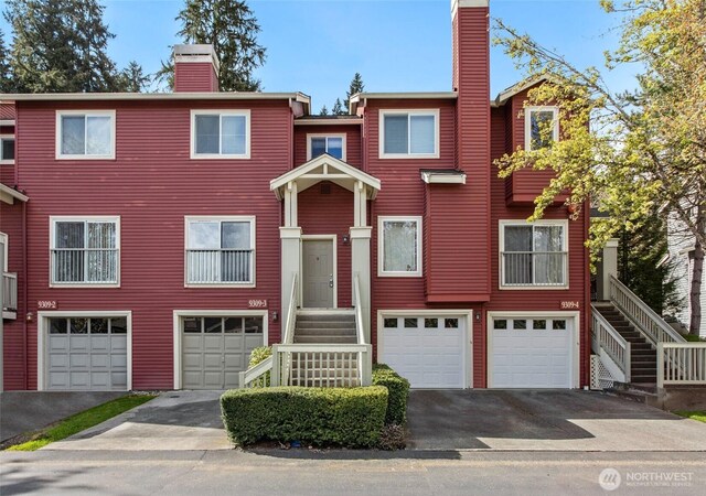 9309 177th Pl NE Unit 3, Redmond, WA 98052 - view of property featuring driveway, a chimney, and a garage