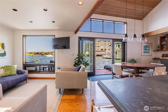living room with recessed lighting, vaulted ceiling, and light wood-type flooring