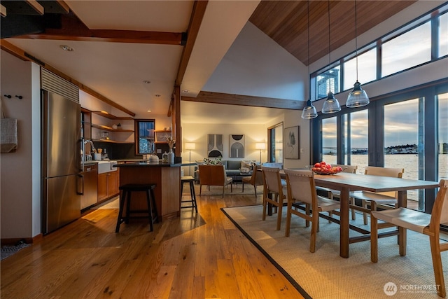 2235 Fairview Ave E Unit 12, Seattle, WA 98102 - dining room with light wood-style flooring, a water view, and a high ceiling
