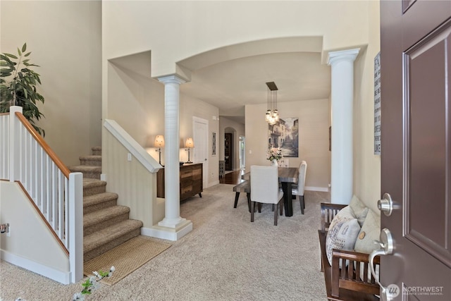 5603 116th St NE, Marysville, WA 98271 - dining area featuring carpet flooring, arched walkways, decorative columns, and stairway