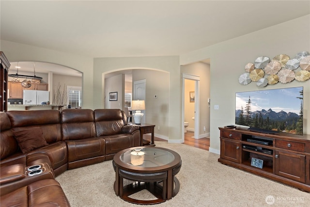 5603 116th St NE, Marysville, WA 98271 - living area with arched walkways, baseboards, and light carpet