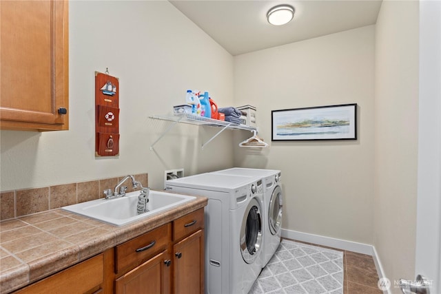 5603 116th St NE, Marysville, WA 98271 - clothes washing area with washing machine and clothes dryer, cabinet space, a sink, baseboards, and light tile patterned floors