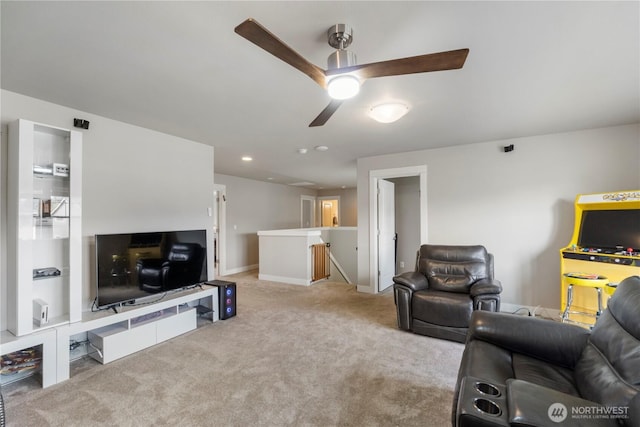 carpeted living area with a ceiling fan, baseboards, and recessed lighting