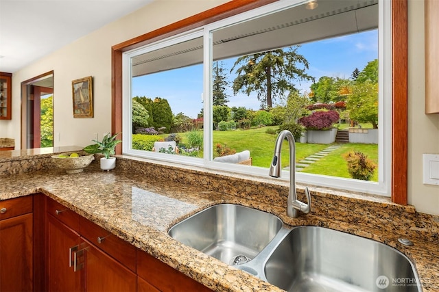 details featuring stone counters and a sink