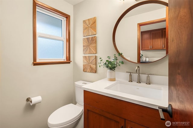half bathroom with toilet and vanity
