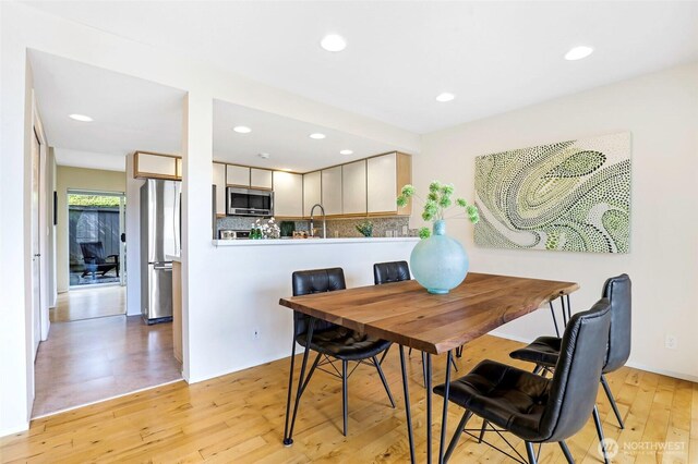 dining area with recessed lighting and light wood-type flooring