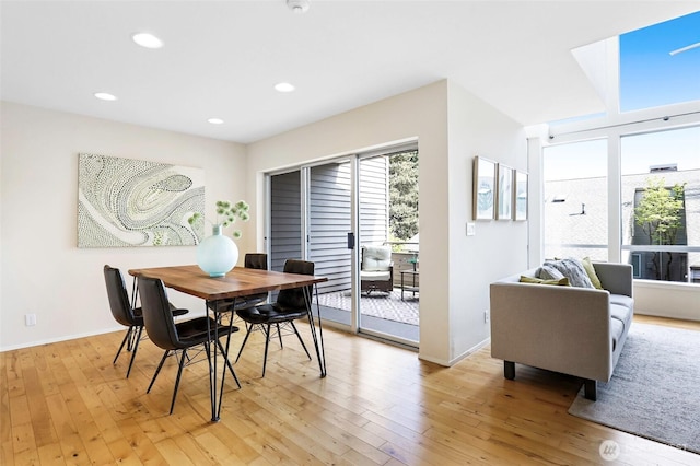 dining area with light wood-style floors, baseboards, and recessed lighting