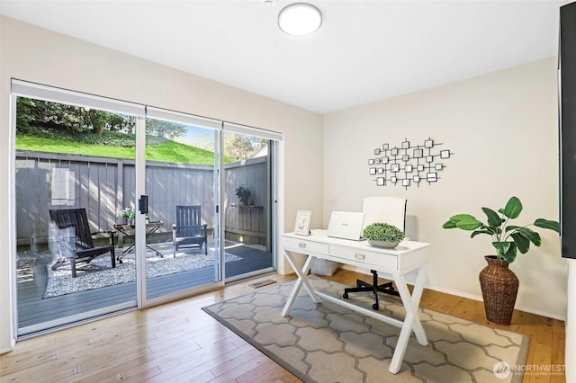 home office featuring wood-type flooring and baseboards