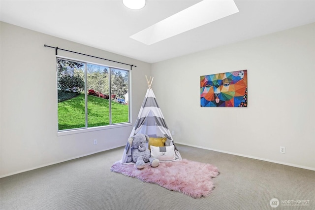 rec room featuring carpet floors, a skylight, and baseboards