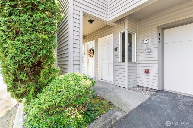 entrance to property featuring an attached garage