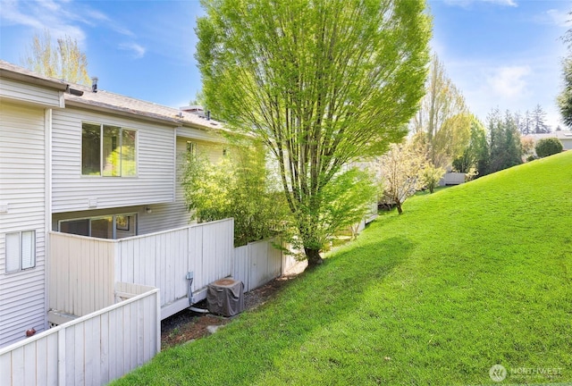 view of yard with fence and central AC