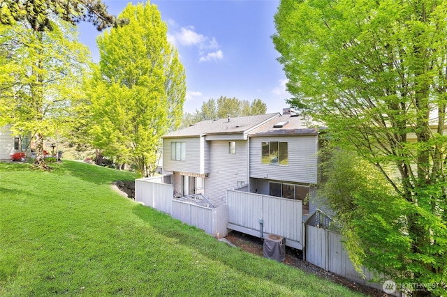 back of property with a lawn