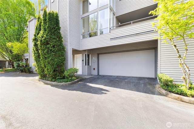 exterior space with an attached garage and aphalt driveway