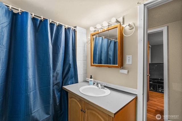 full bathroom with vanity, wood finished floors, and a shower with shower curtain