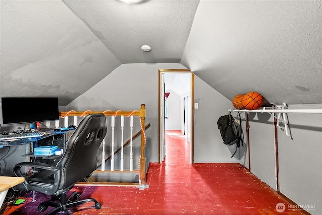 office area with a textured ceiling and vaulted ceiling