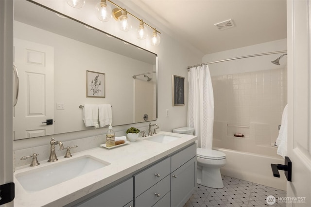 bathroom featuring visible vents, a sink, shower / bathtub combination with curtain, and toilet