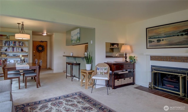 carpeted living room with baseboards and a fireplace with flush hearth