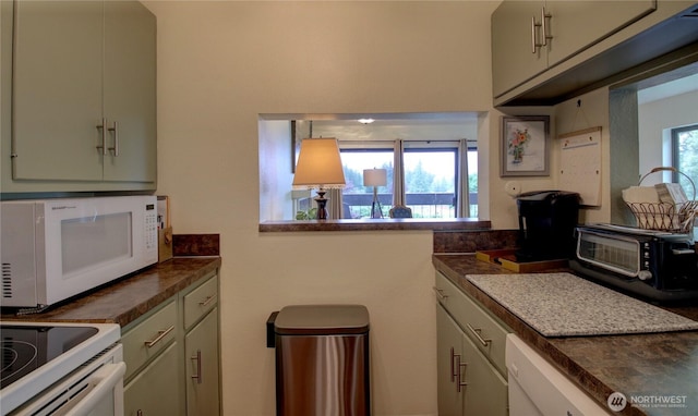 kitchen featuring dark countertops, a toaster, and white microwave