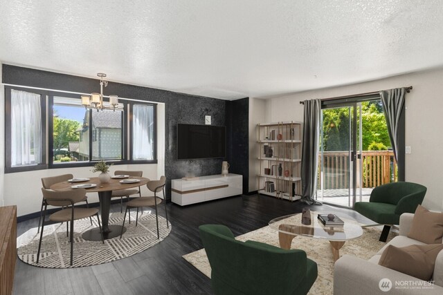 living area with baseboards, a textured ceiling, a chandelier, and dark wood-style floors